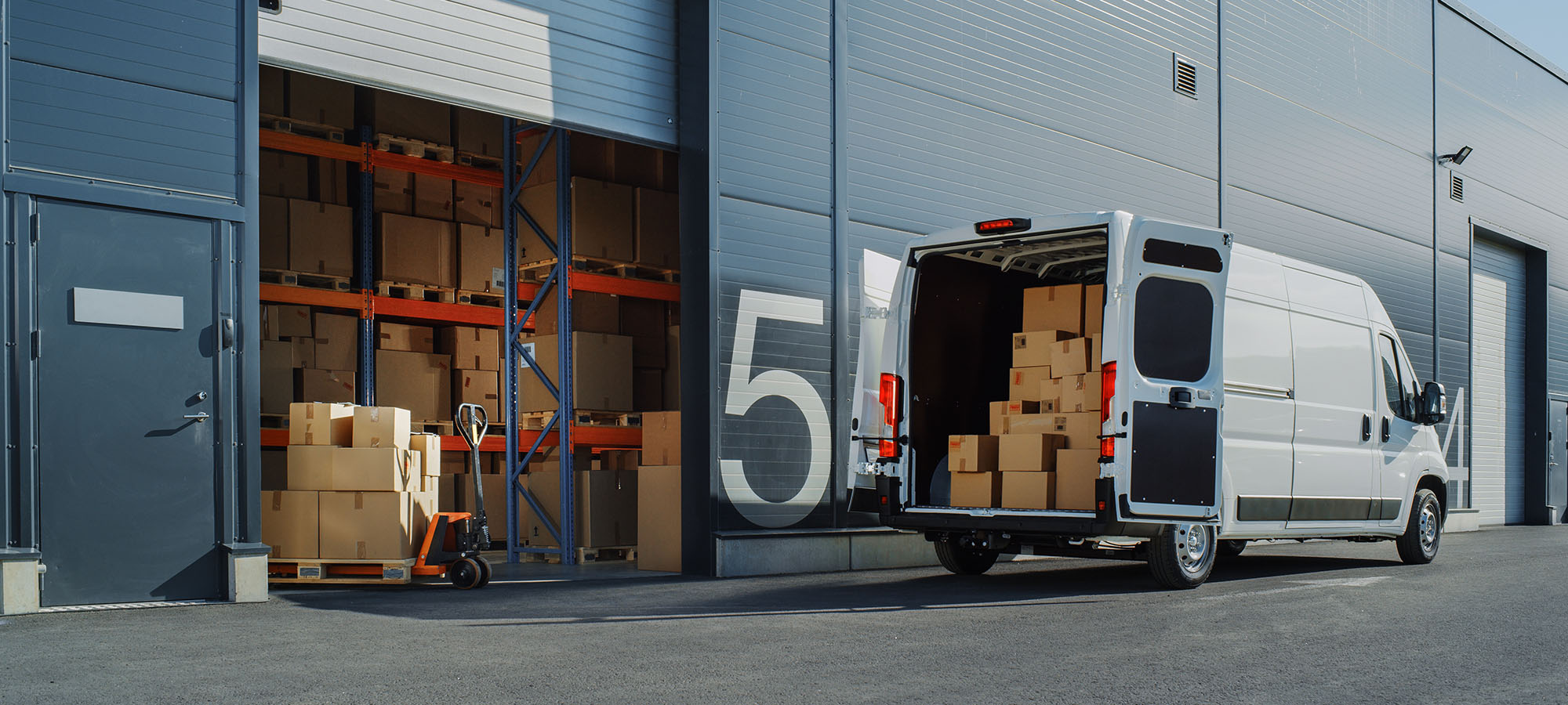 A delivery van being loaded with products at a warehouse, showcasing efficient logistics for Yankee.