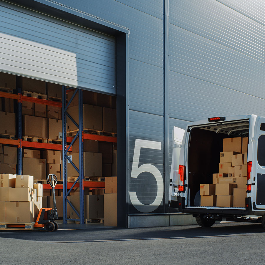 A delivery van being loaded with products at a warehouse, showcasing efficient logistics for Yankee.