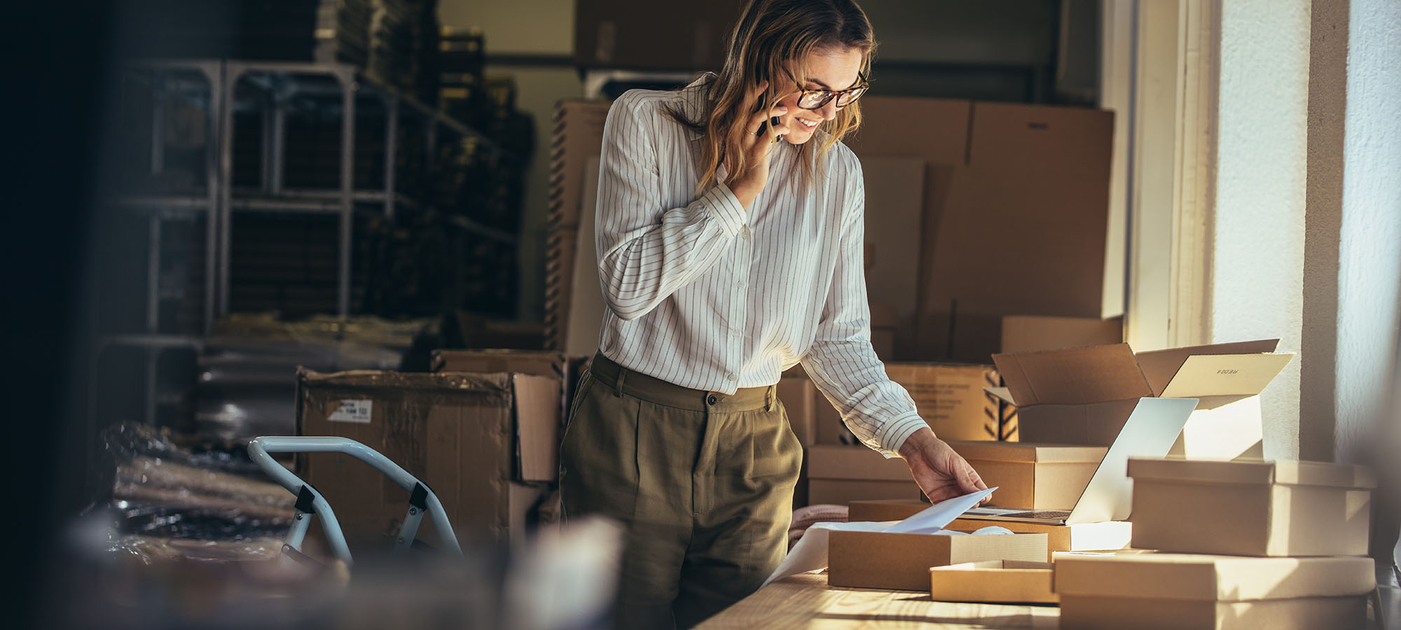 A woman preparing packages in a warehouse, symbolizing streamlined fulfillment processes implemented by Marketix