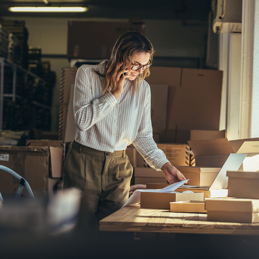 A woman preparing packages in a warehouse, symbolizing streamlined fulfillment processes implemented by Marketix